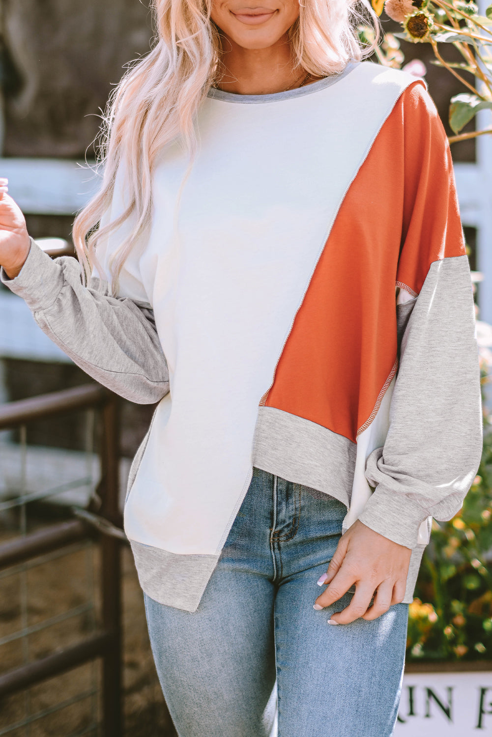 Light French beige colorblock long sleeve top with irregular hem and stitch detailing