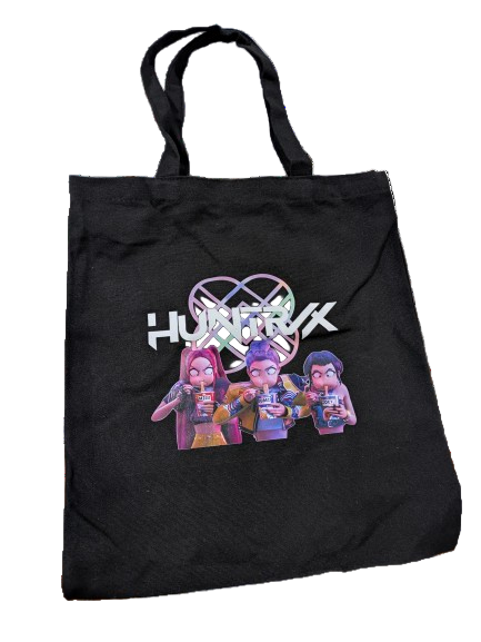 Black canvas tote bag featuring K-POP DEMON HUNTERS Trio mid-ramen break with stylized logo