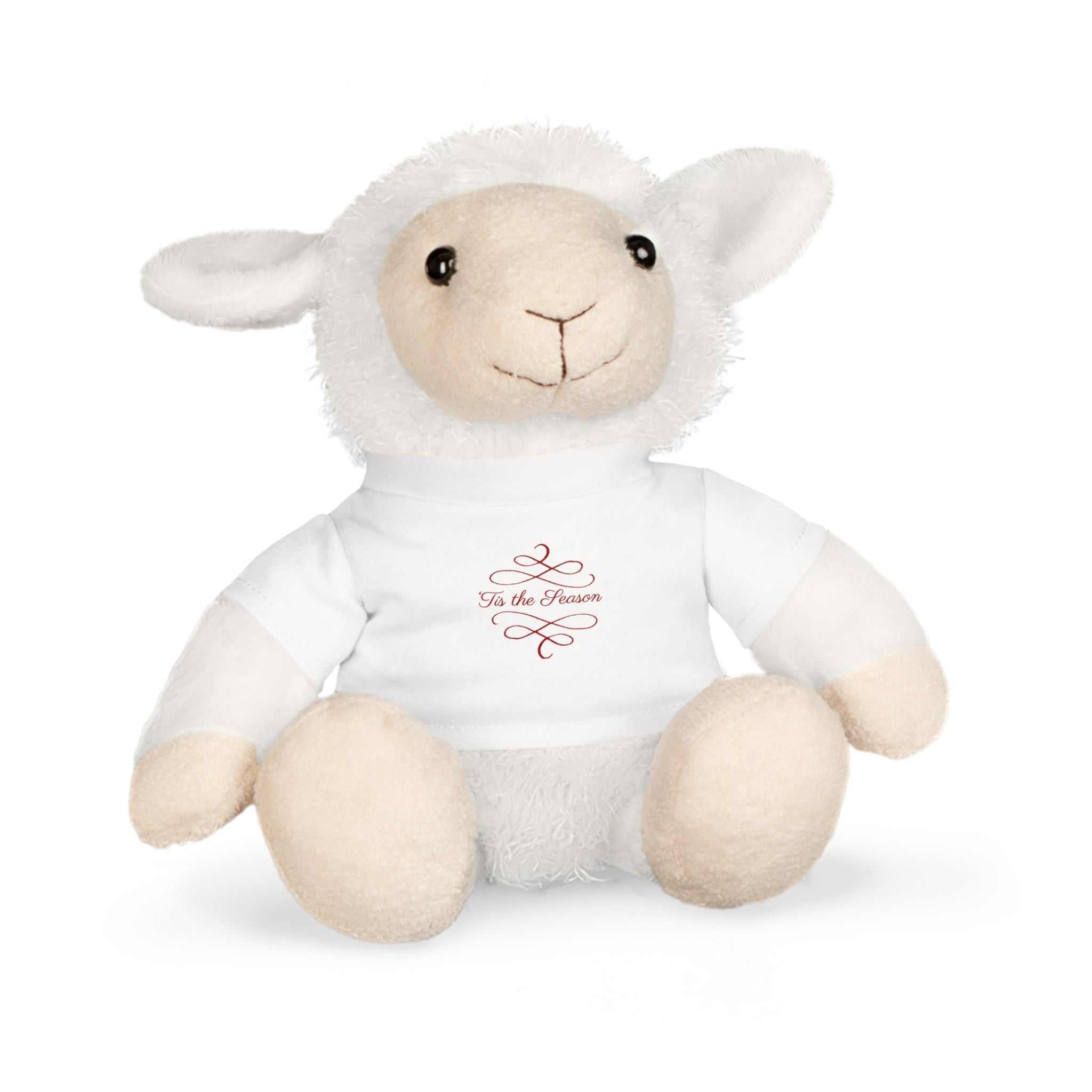 White plush sheep toy wearing white holiday T-shirt with "Tis the Season" text