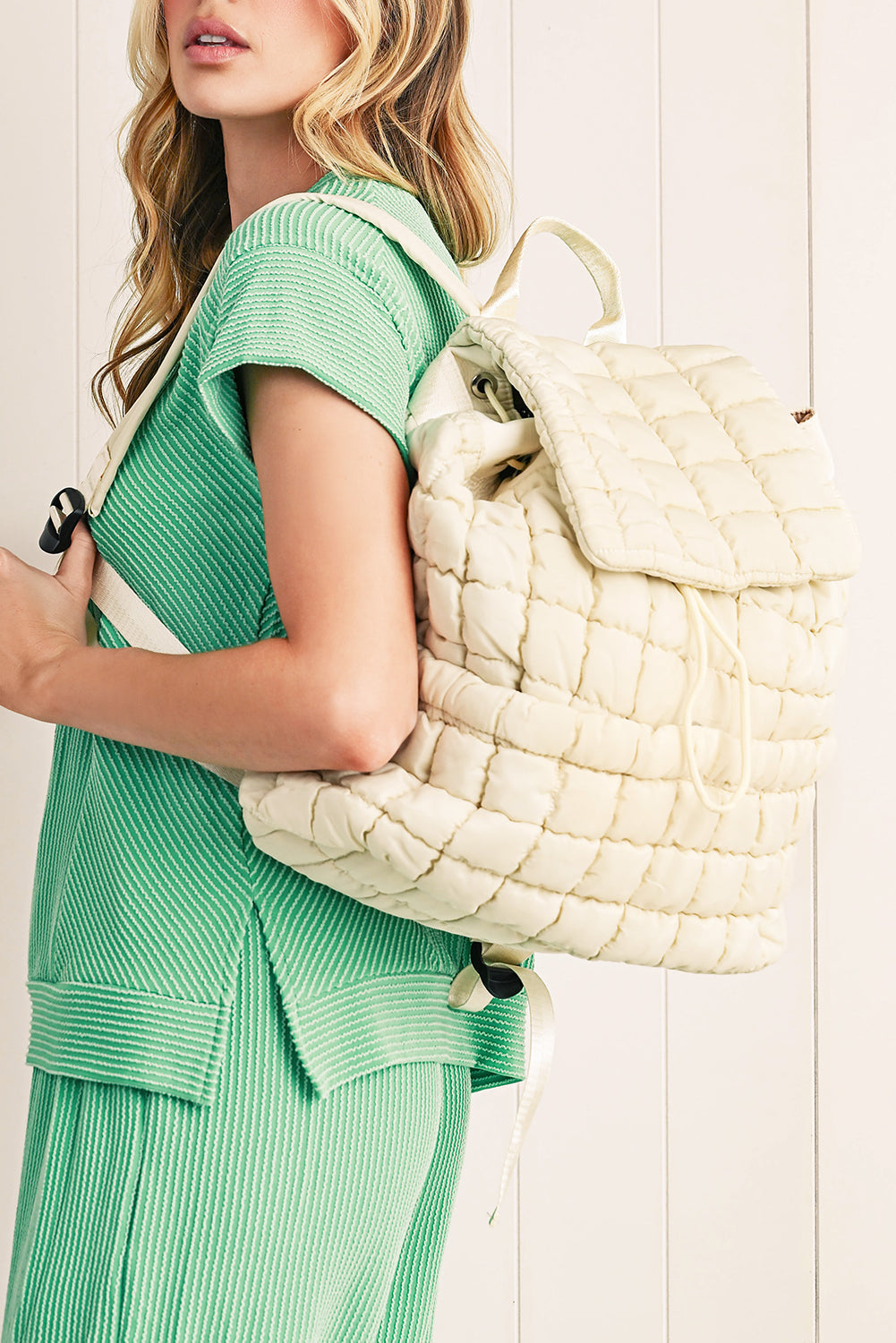 Black solid flapped quilted puffer backpack with spacious interior and stylish design