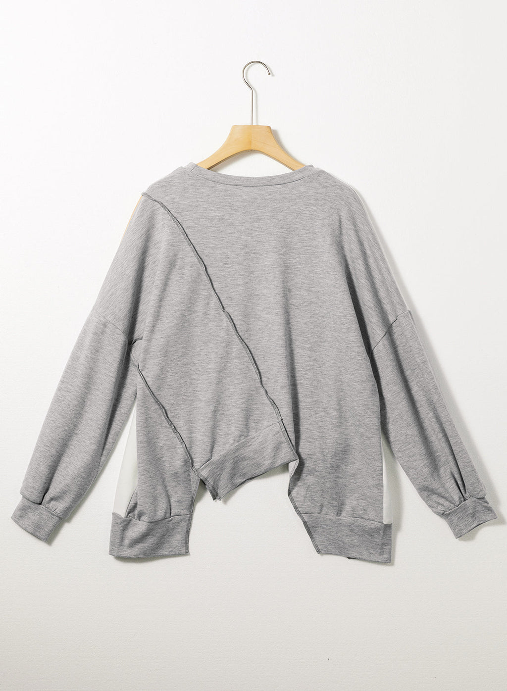 Light French beige colorblock long sleeve top with irregular hem and stitch detailing