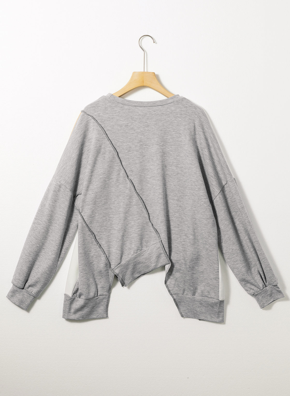 Light French beige colorblock long sleeve top with irregular hem and stitch detailing