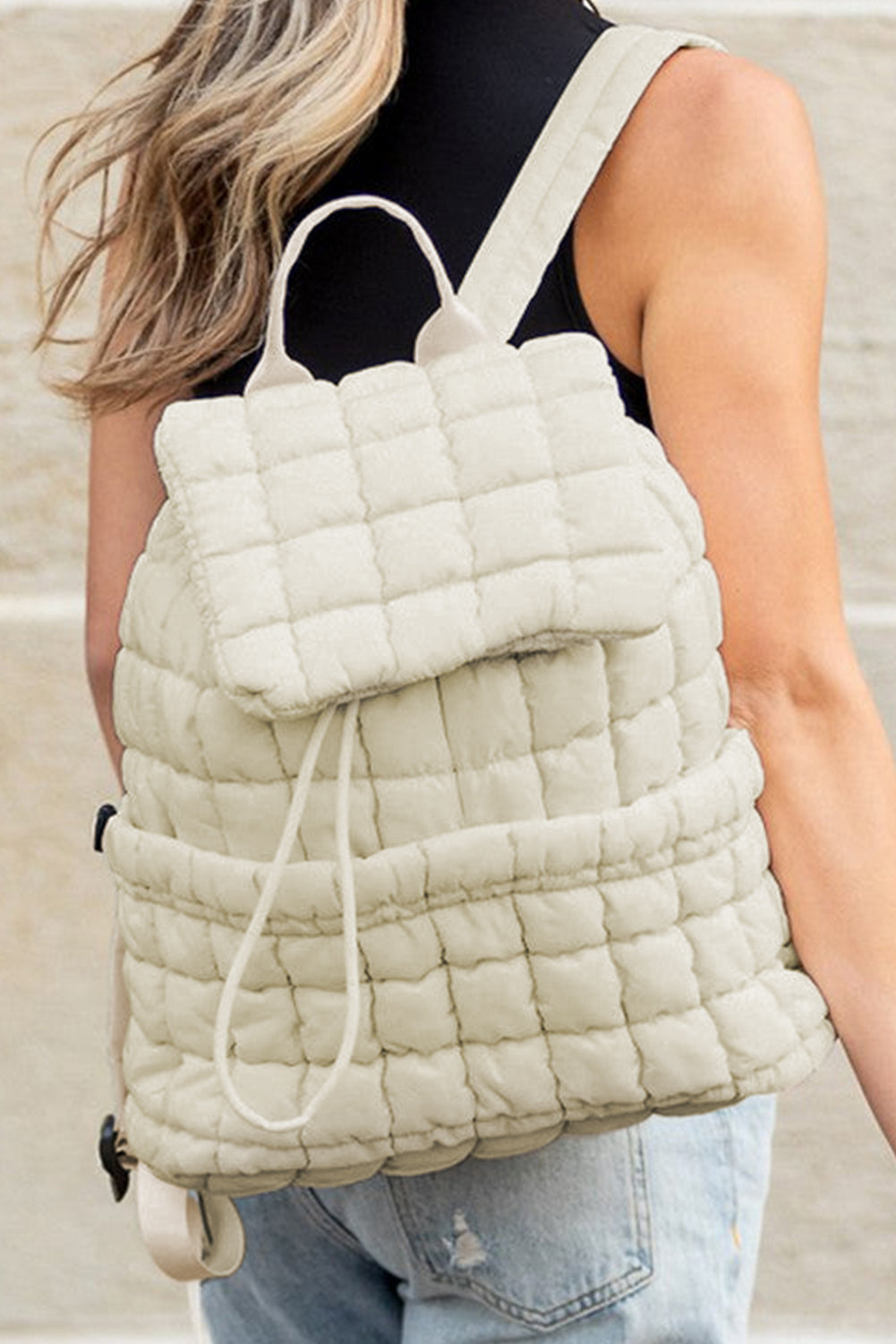 Black solid flapped quilted puffer backpack with spacious interior and stylish design