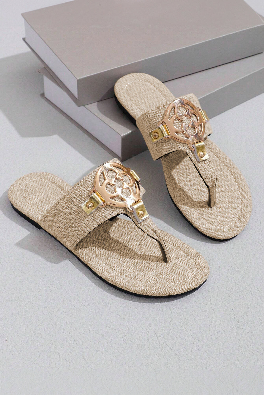 Beige leather thong slippers with stylish metal decor and adjustable strap design