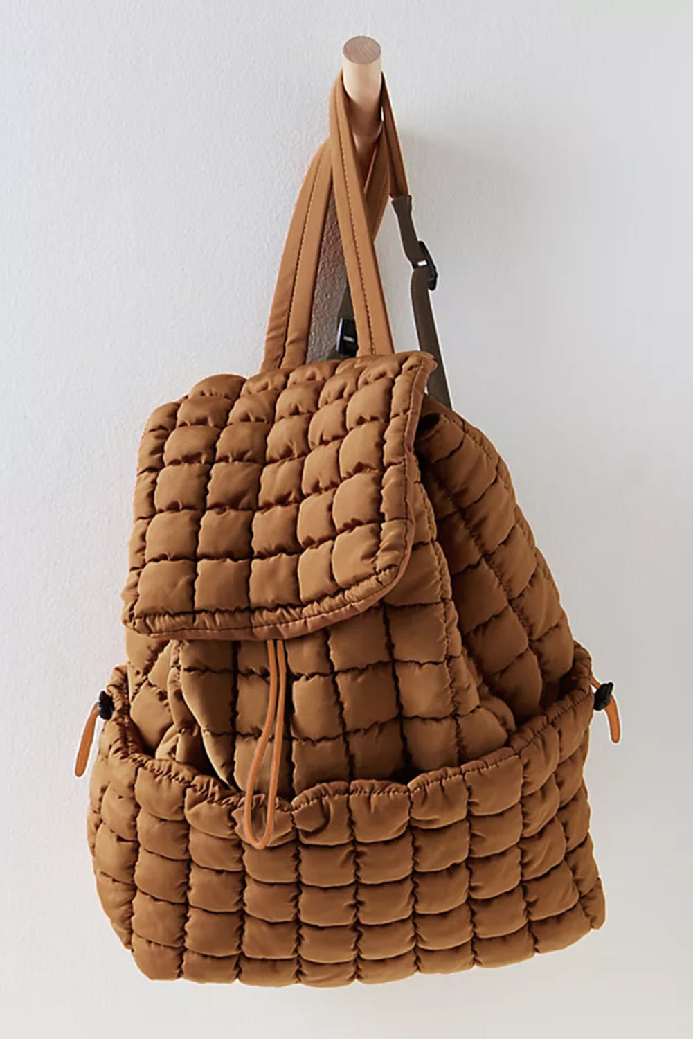 Black solid flapped quilted puffer backpack with spacious interior and modern stylish design