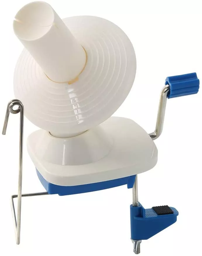 Manually operated winding machine with 4 ounce capacity for yarn cakes, featuring a clamp, crank handle, and shrouded bobbin