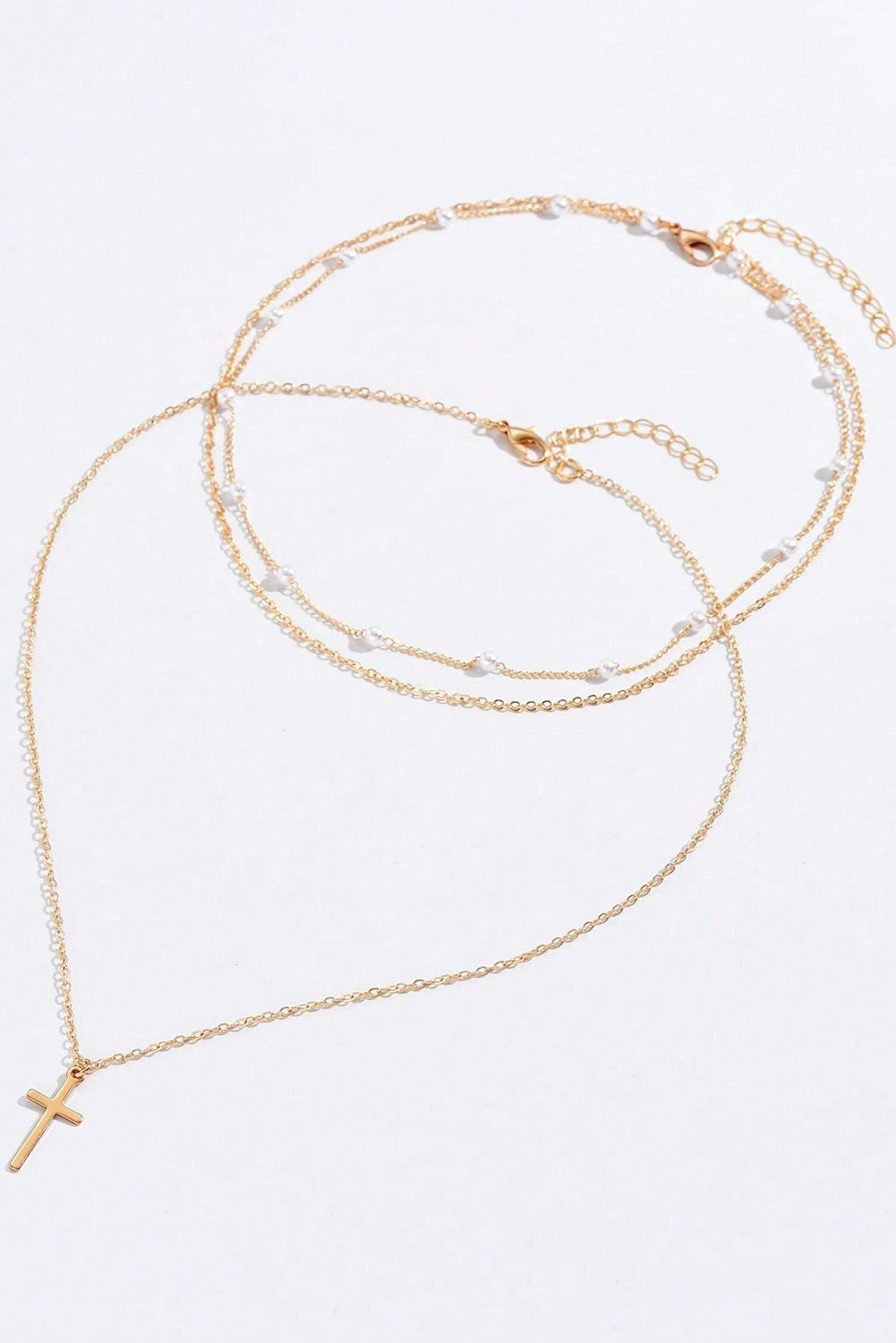 Gold plated cross pendant with pearl decoration and triple layer chain necklace