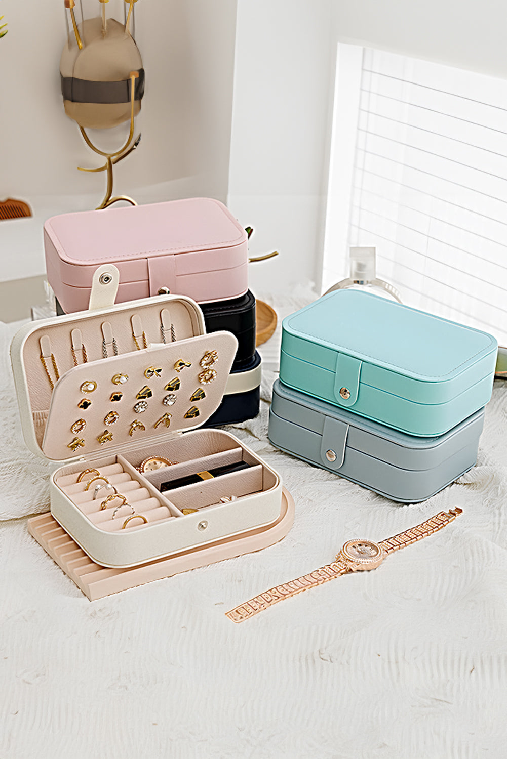 White multi layers lint-lined portable jewelry organizer with buttoned closure and multiple sections