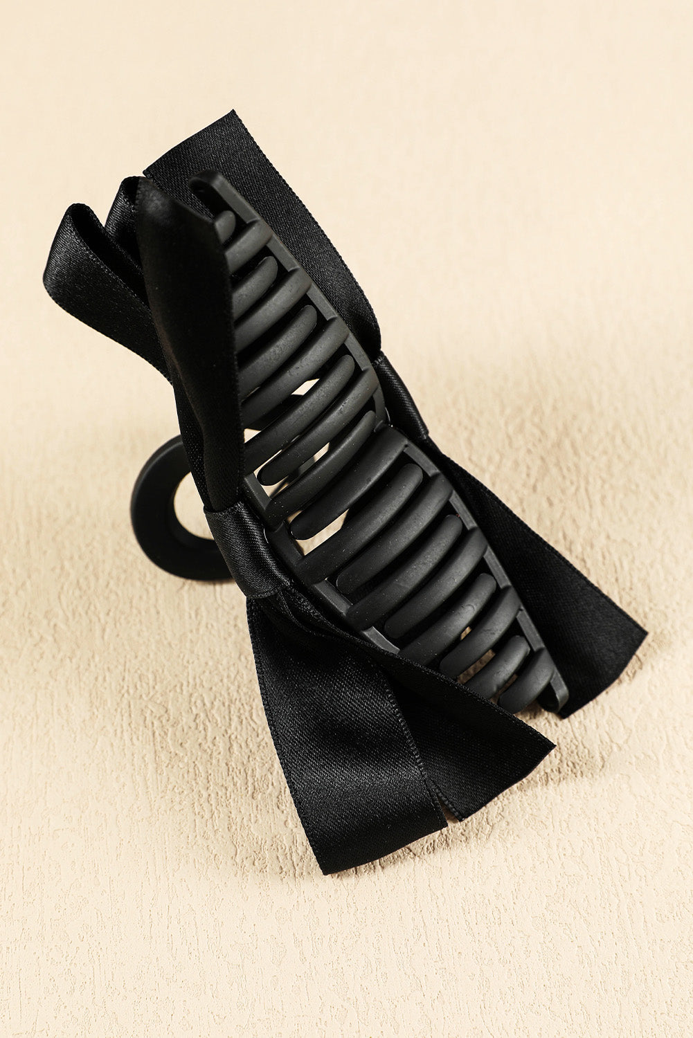 Large black hair claw clip with stylish bow decor for securing hair