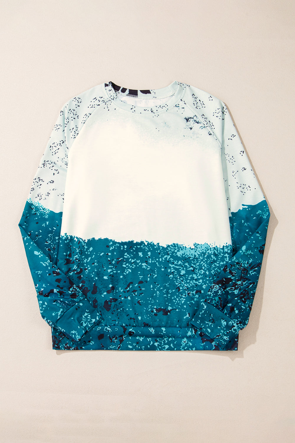 Blue tie dye cow color block pullover sweatshirt with raglan sleeves and medium elasticity