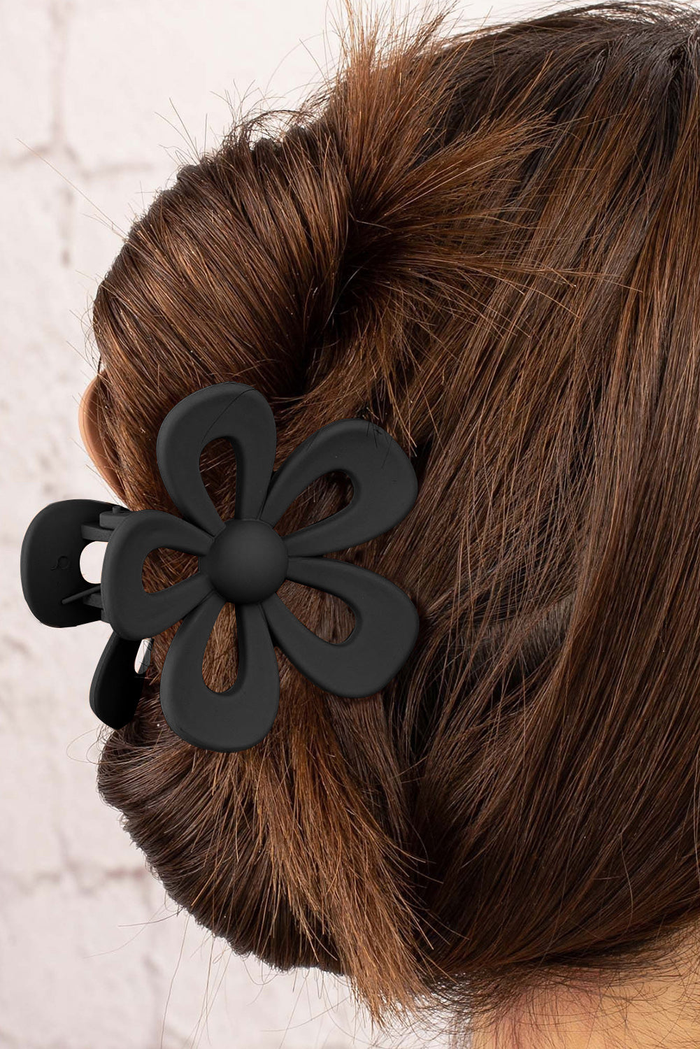 Black sweet hollowed flower shaped claw clip with frosting finish and durable plastic design