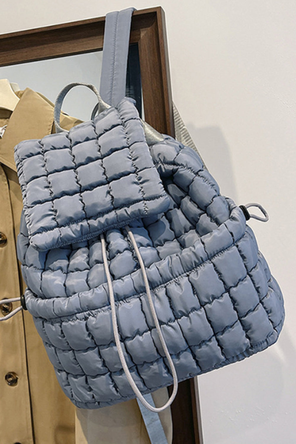 Black solid flapped quilted puffer backpack with spacious interior and modern design