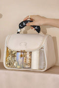 Beige clear makeup bag with TASTY print and handle showing inside pocket storage