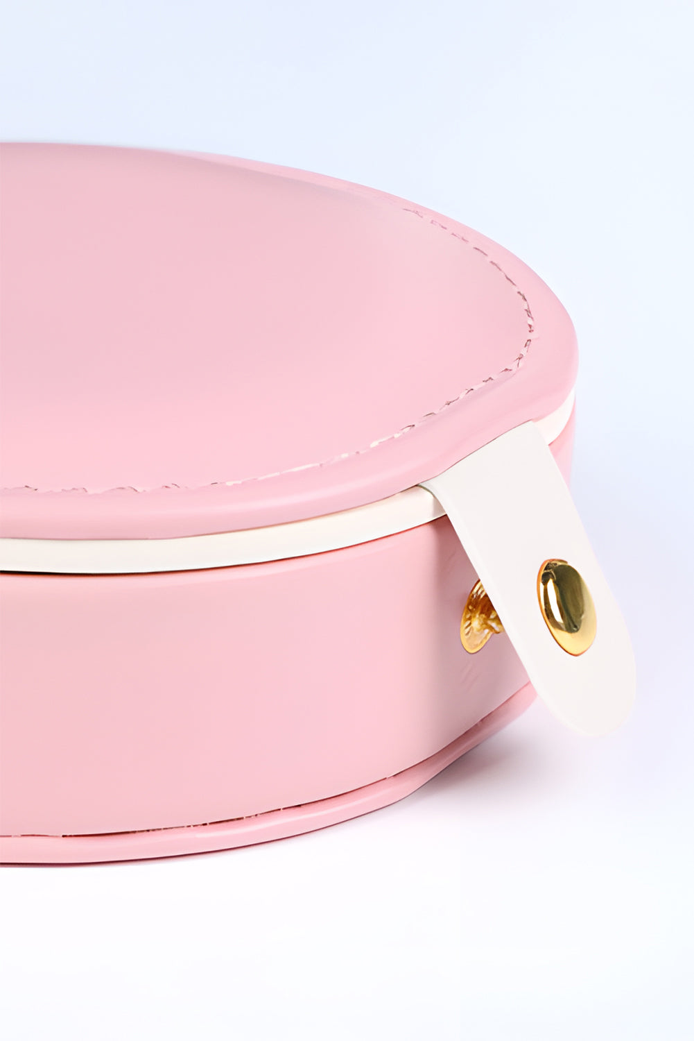 Light pink jewelry organizer case with mirror and snap button closure compact round shape