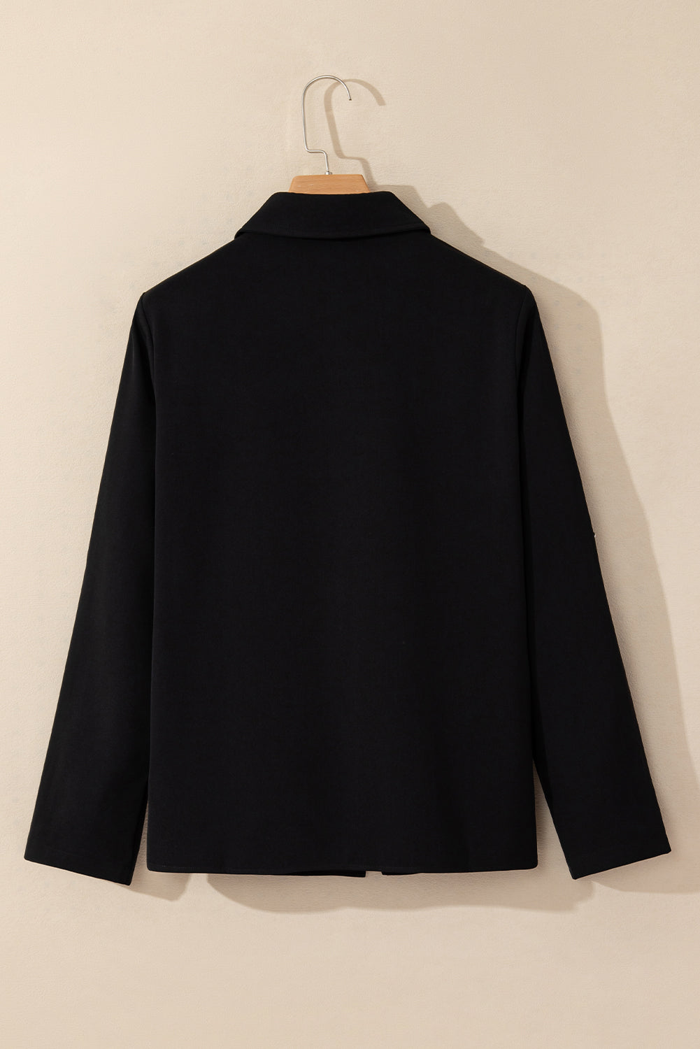Black jacket with collar and tab sleeve detail, zip-up front
