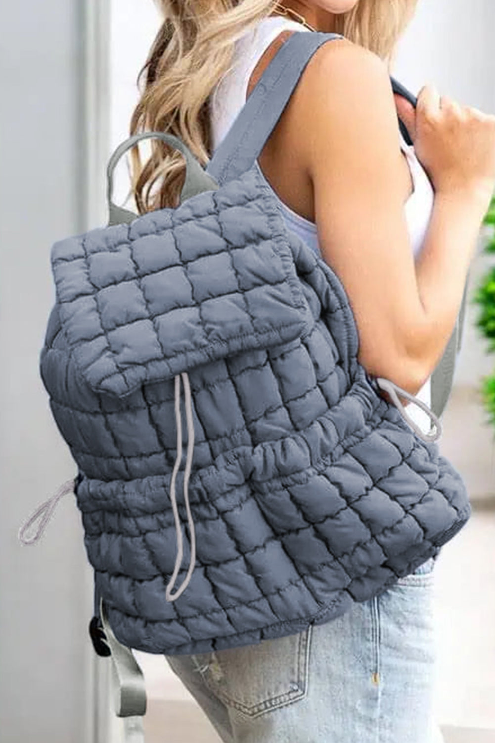 Black solid flapped quilted puffer backpack with spacious interior and modern style