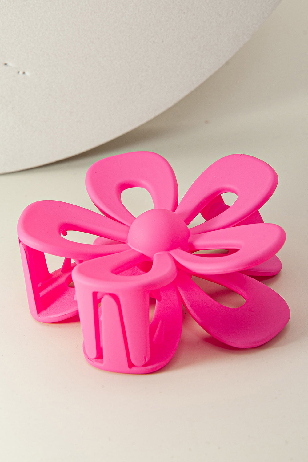 Black sweet hollowed flower shaped claw clip with frosting finish and durable plastic design