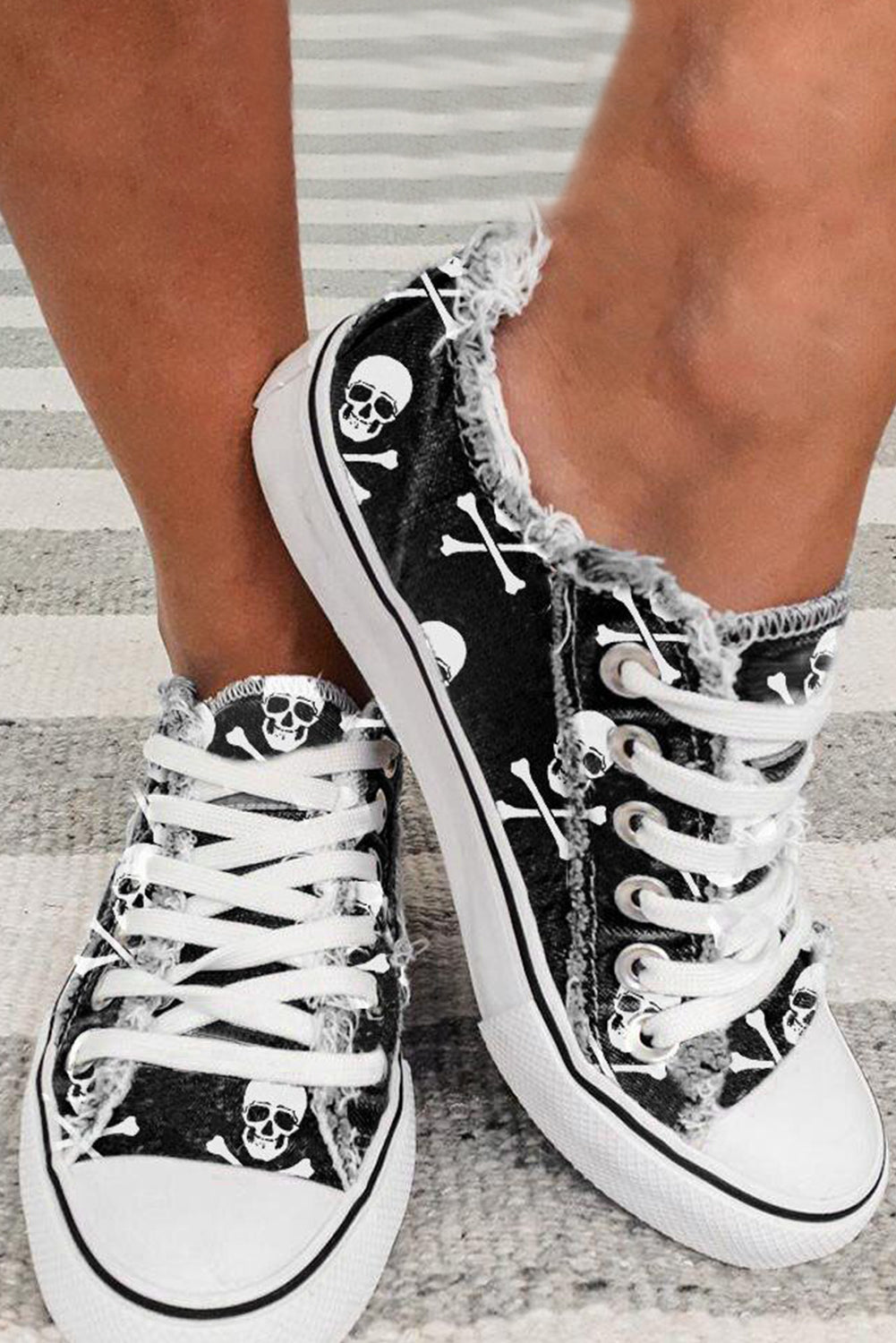 Black skull print lace-up canvas sneakers with size chart in cm and inches