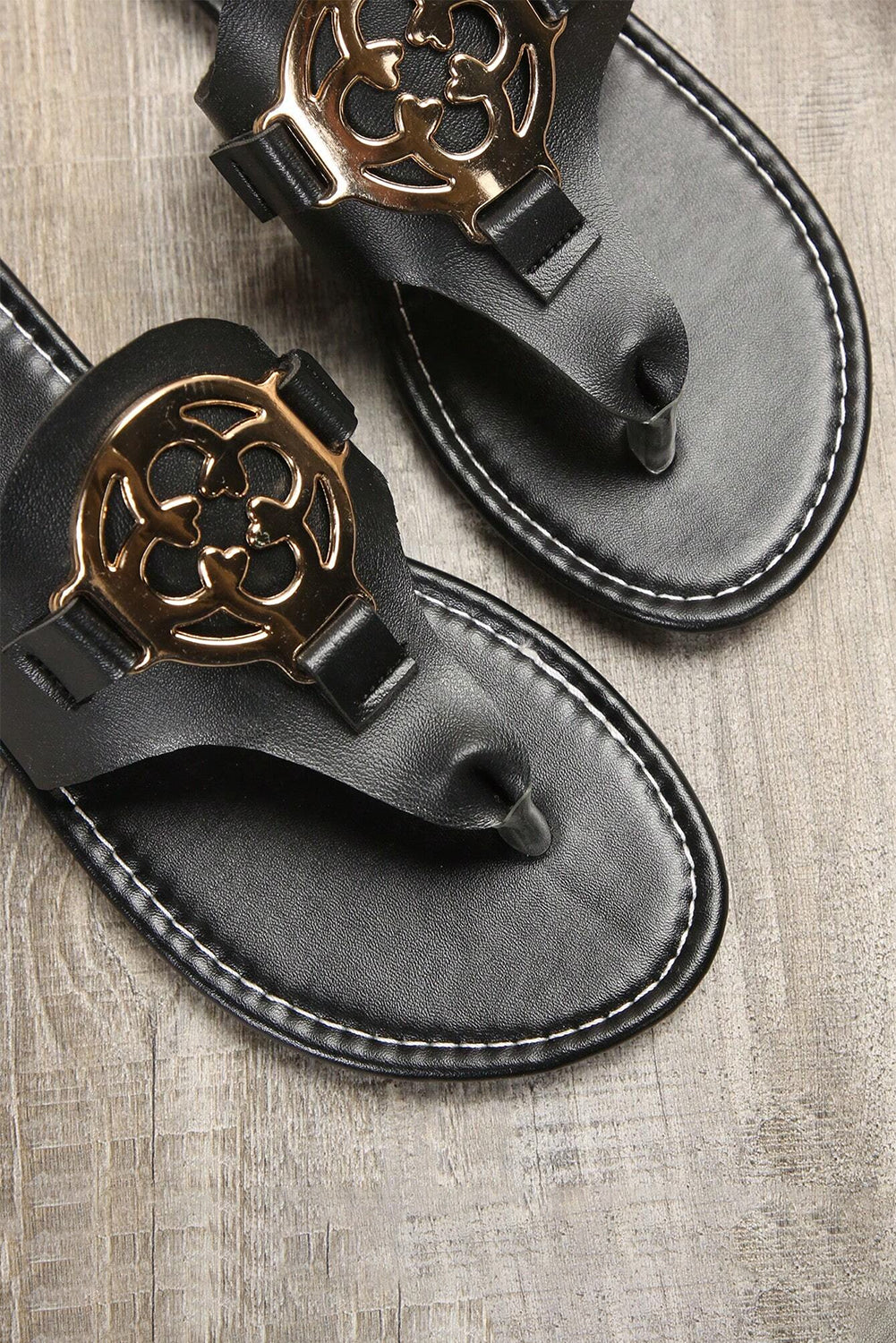 Beige leather thong slippers with stylish metal decor and adjustable strap design