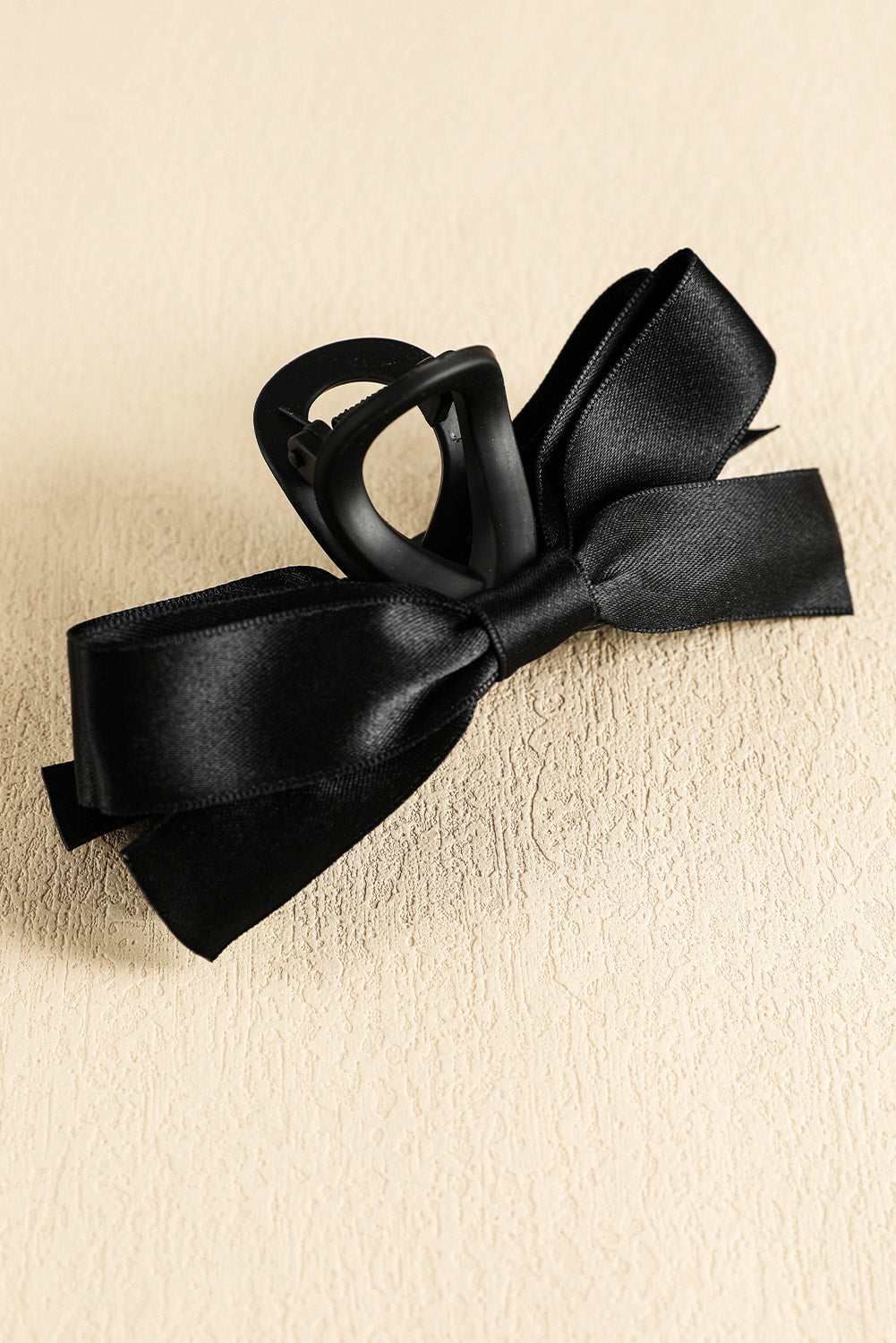 Black bow decor large hair claw clip securing hair elegantly