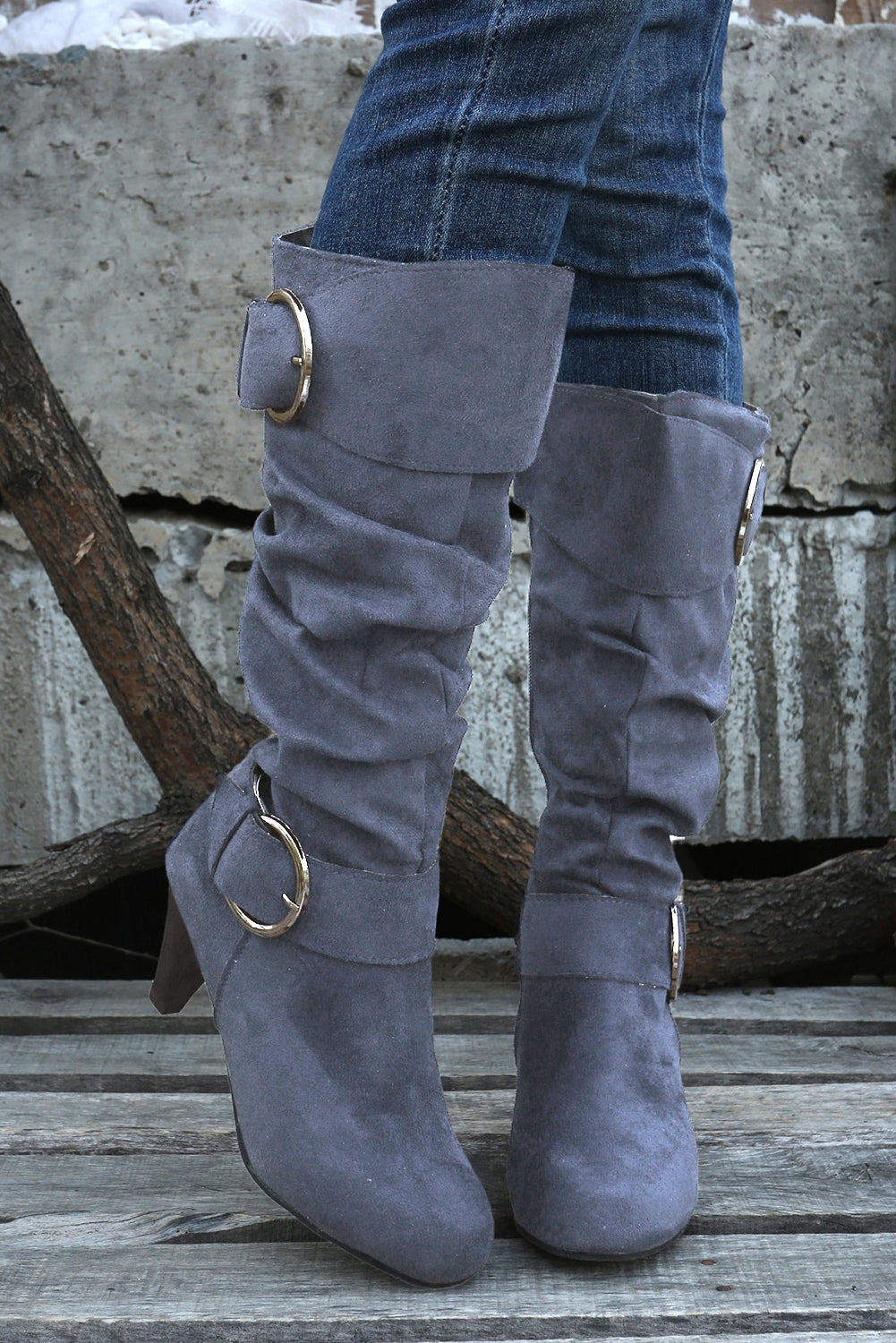 Navy blue mid-calf heeled boots with dual buckle straps and side zip closure