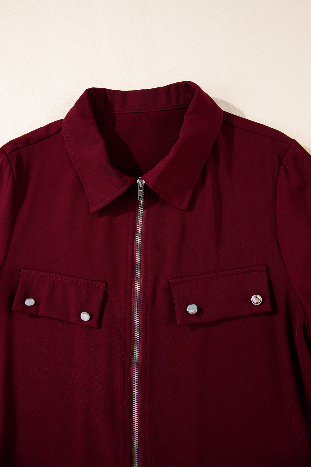 Black collar jacket with tab sleeves and zip-up flap detail