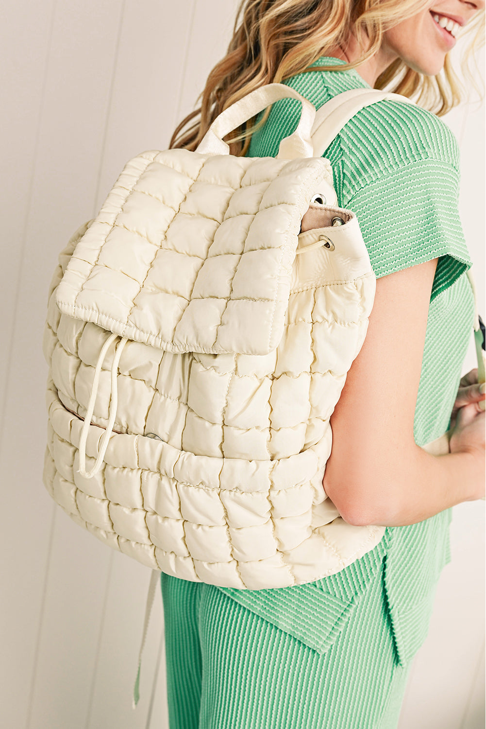 Black solid flapped quilted puffer backpack with spacious interior and modern design