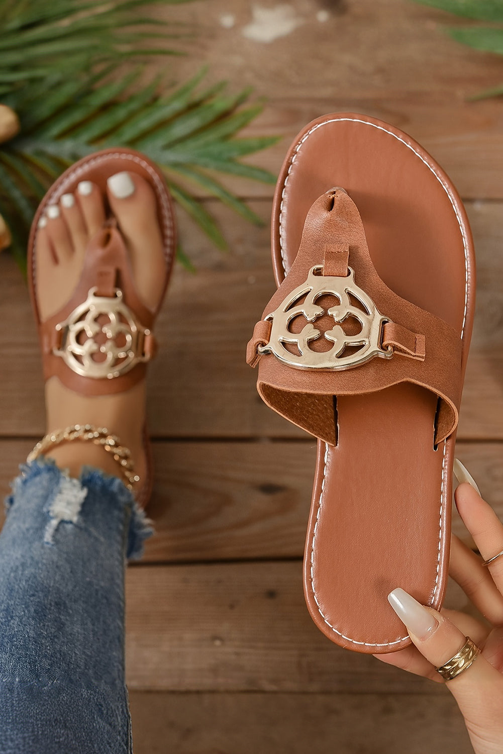 Beige leather thong slippers with stylish metal decor and adjustable strap