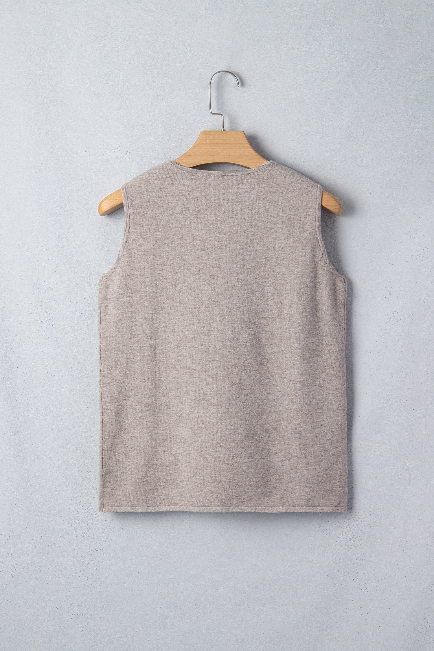 Gray sleeveless knit tank top with metallic star detail and V-neck design