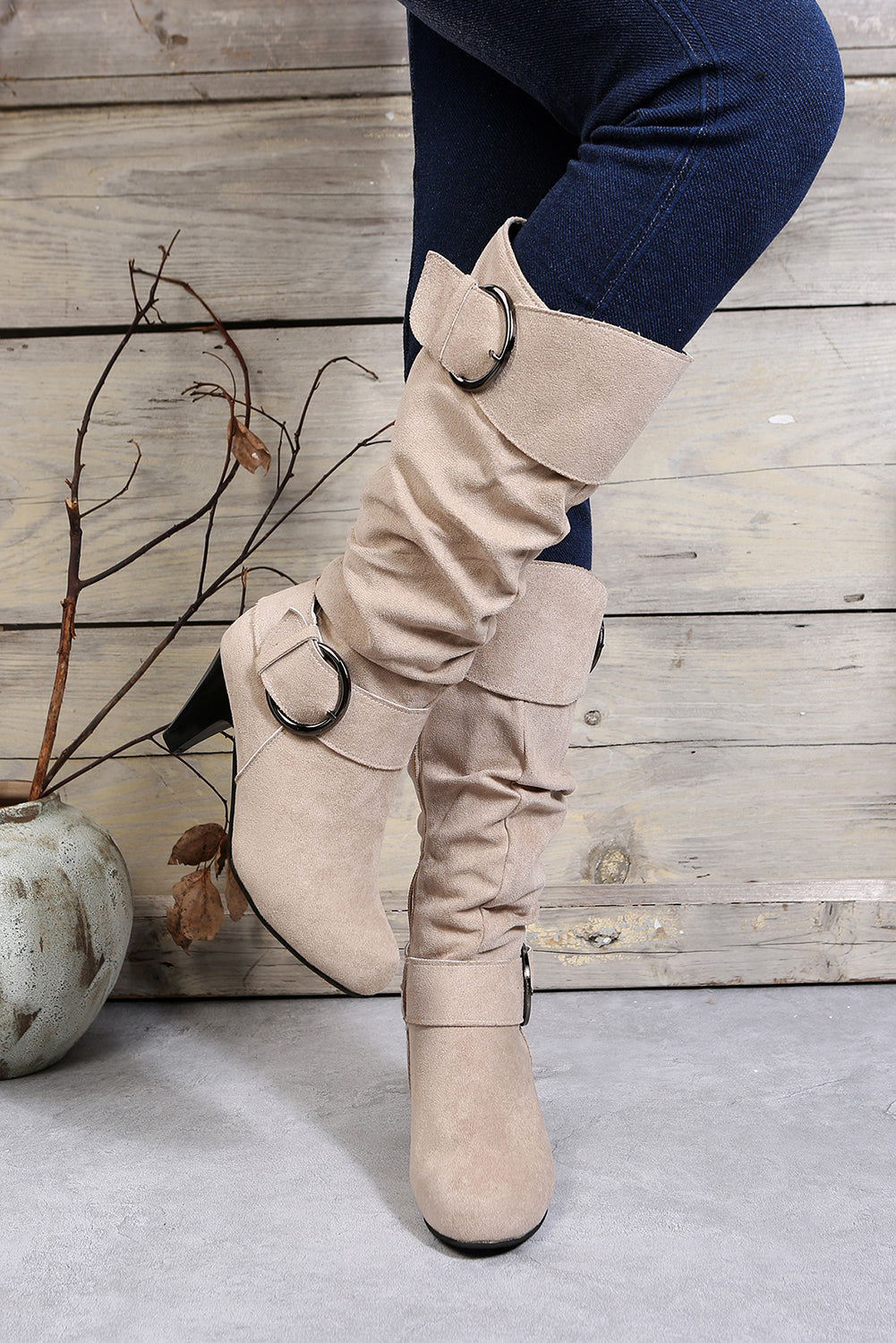 Navy blue mid-calf boots with dual buckle straps and side zip heel